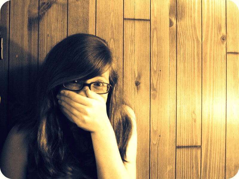 woman covering mouth with hand