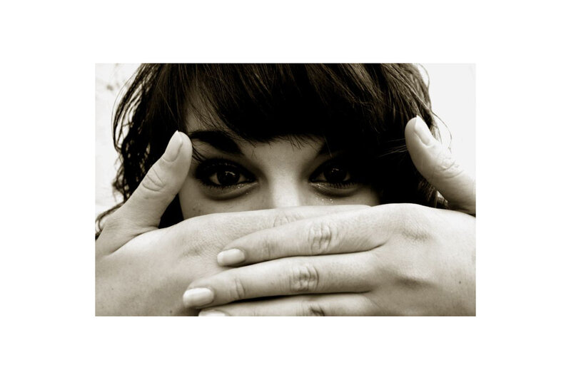 woman covering mouth with hands