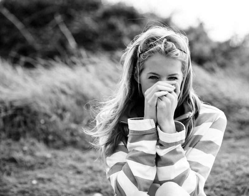 woman covering mouth with hands