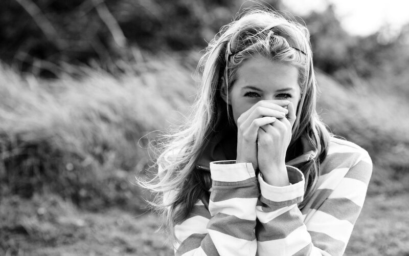 woman covering mouth with hands