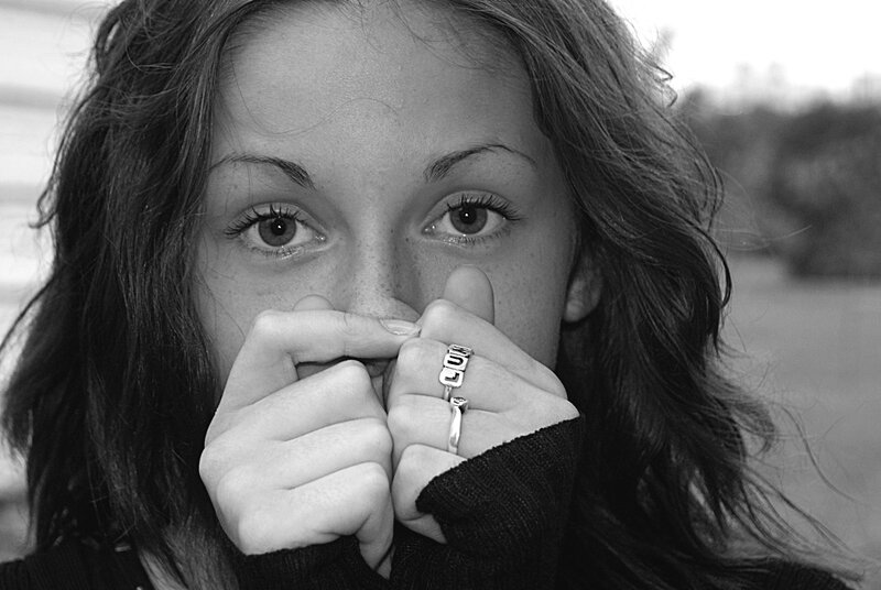 woman covering mouth with hands