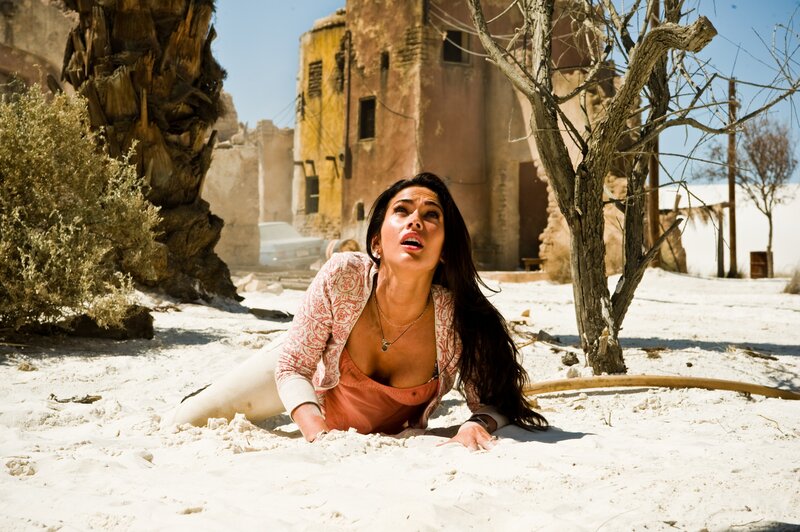 woman crawling in desert sand