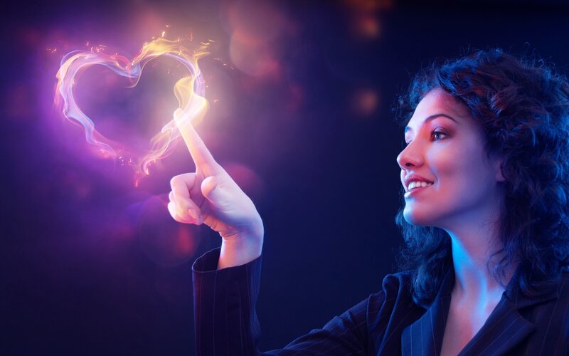 woman creating a heart of light
