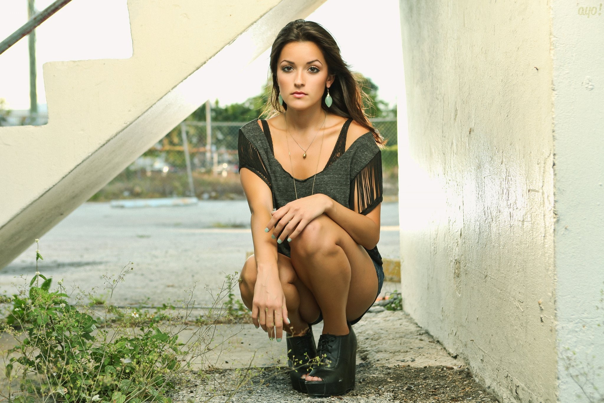 woman crouching by stairs