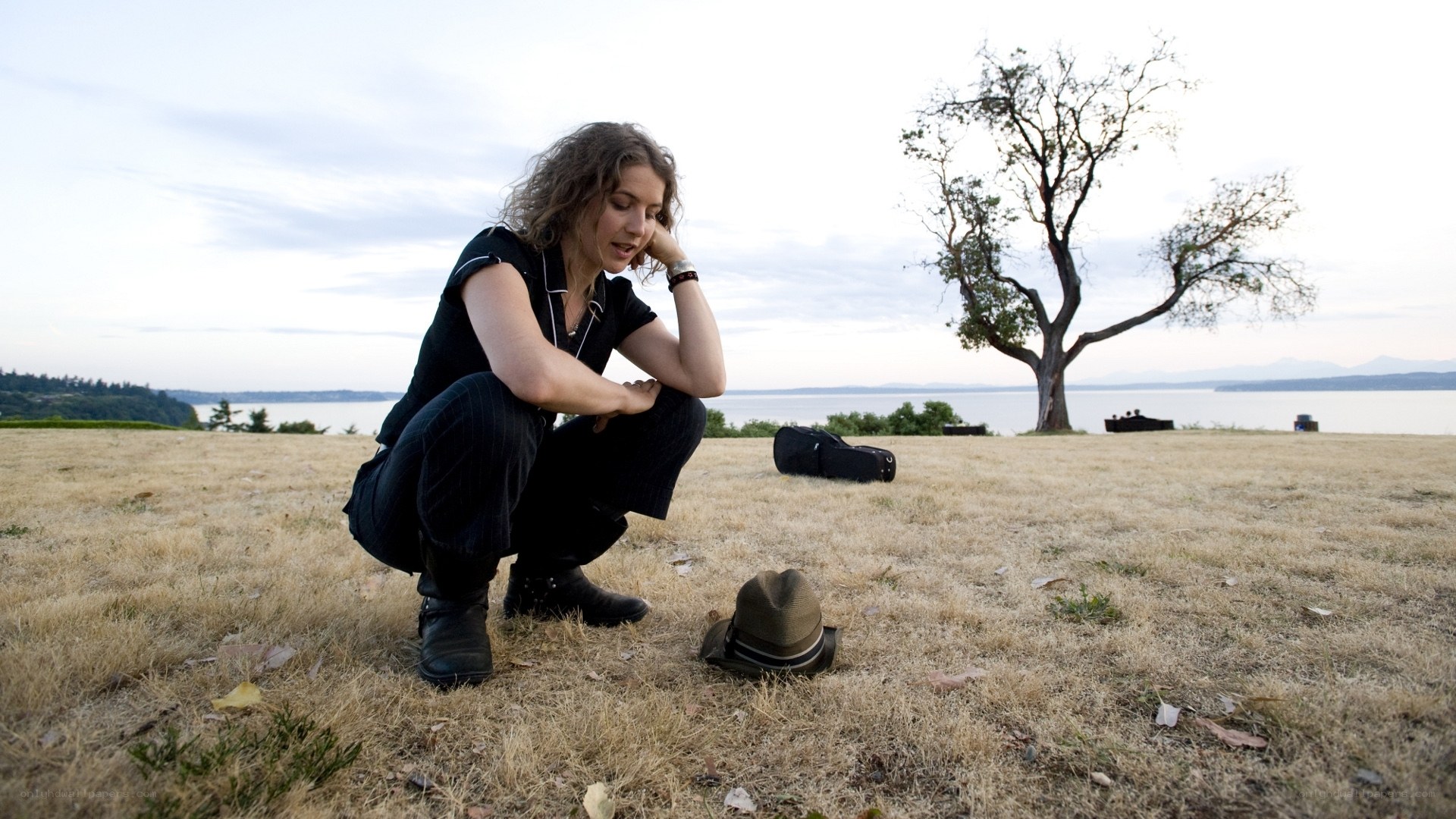 Woman crouching by the water