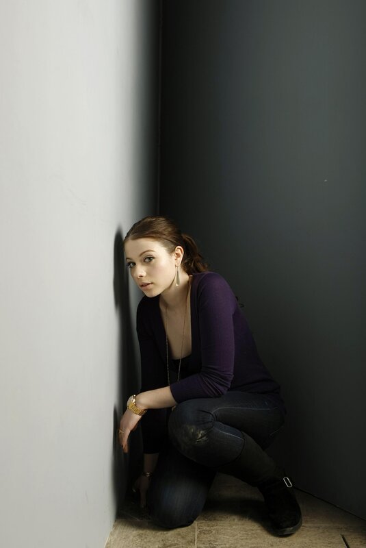 woman crouching in a corner