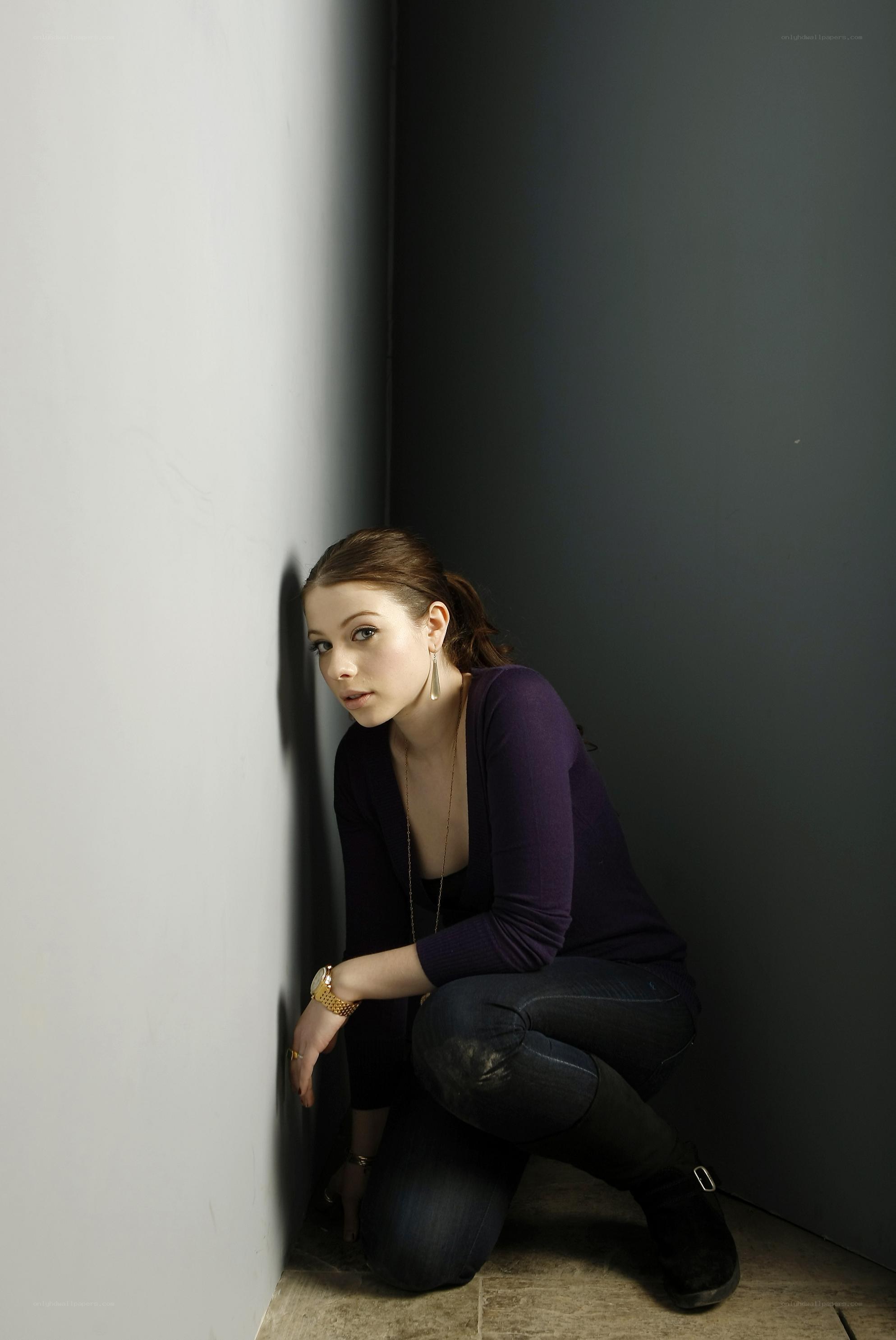 woman crouching in a corner