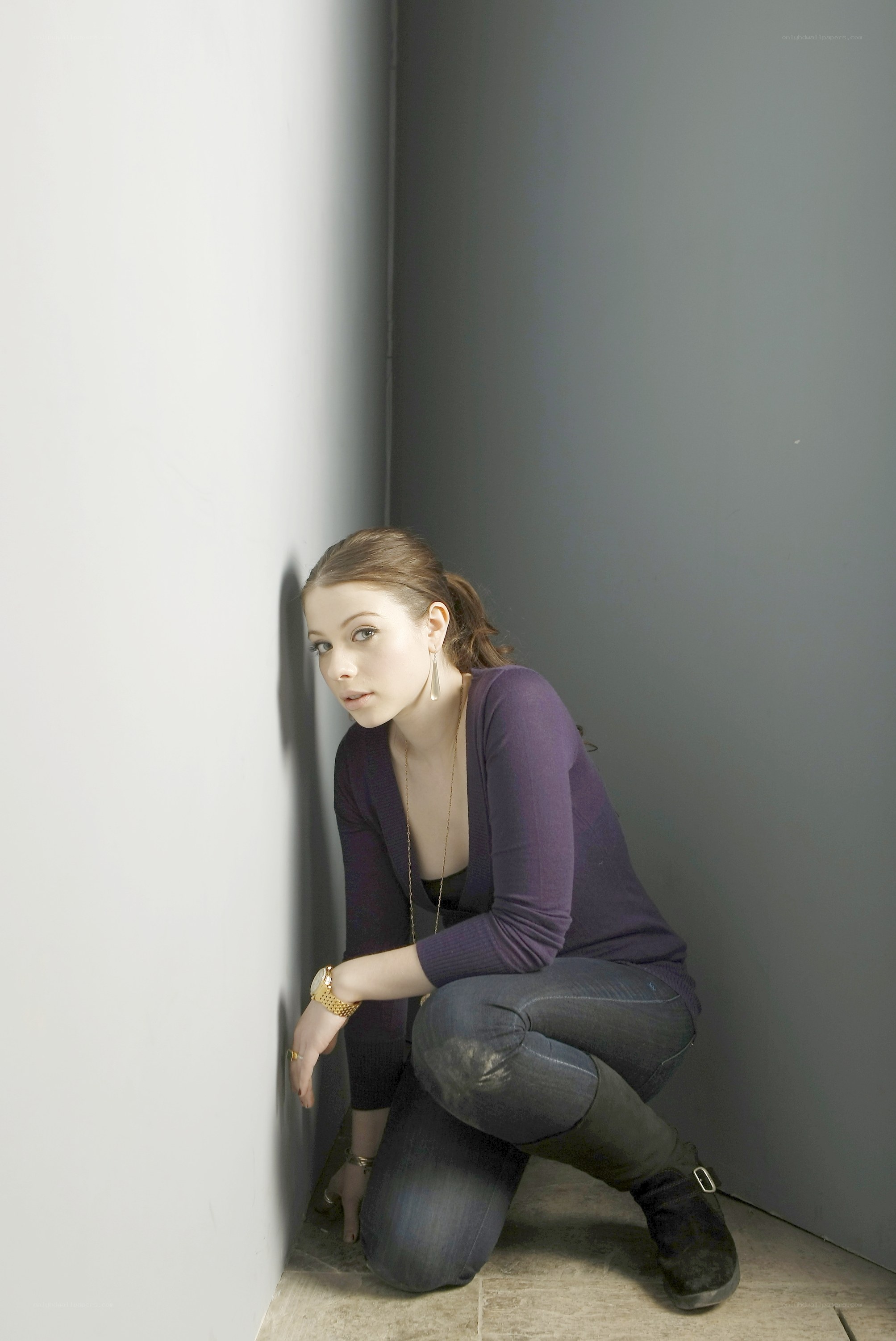 woman crouching in corner