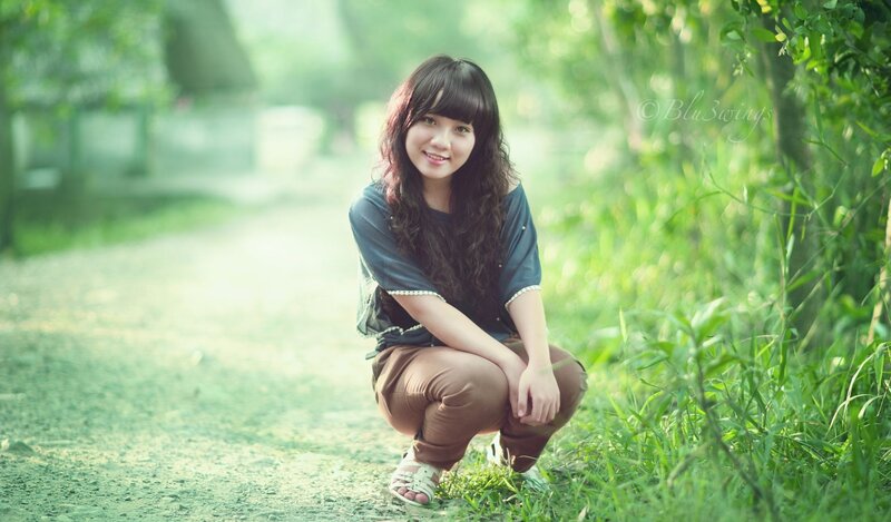 Woman Crouching in Grass — Green, Serene