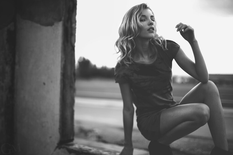 Woman Crouching on Curb