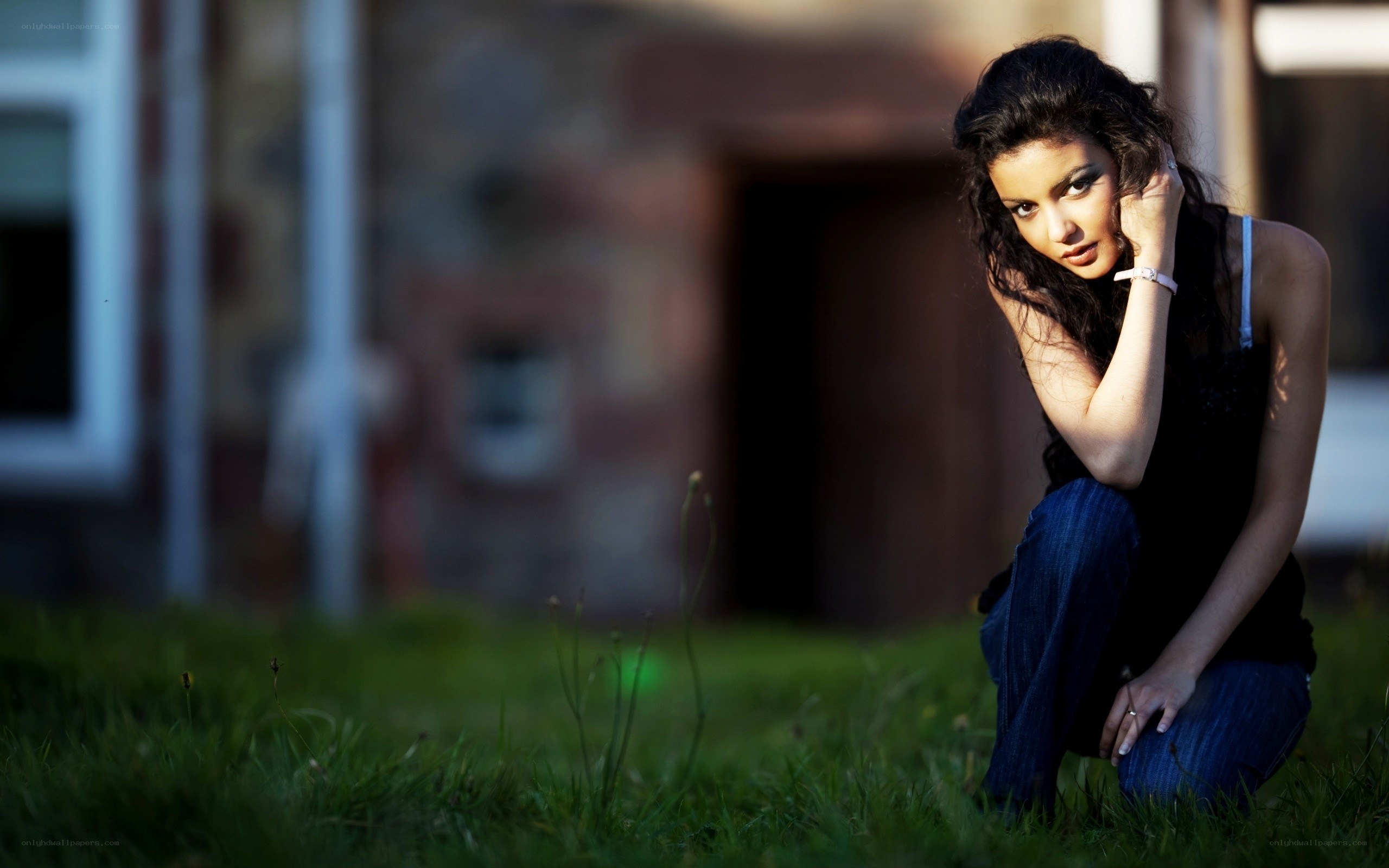 woman crouching on grass