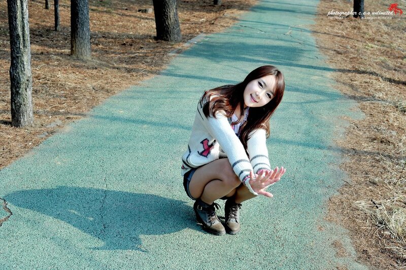woman crouching on path