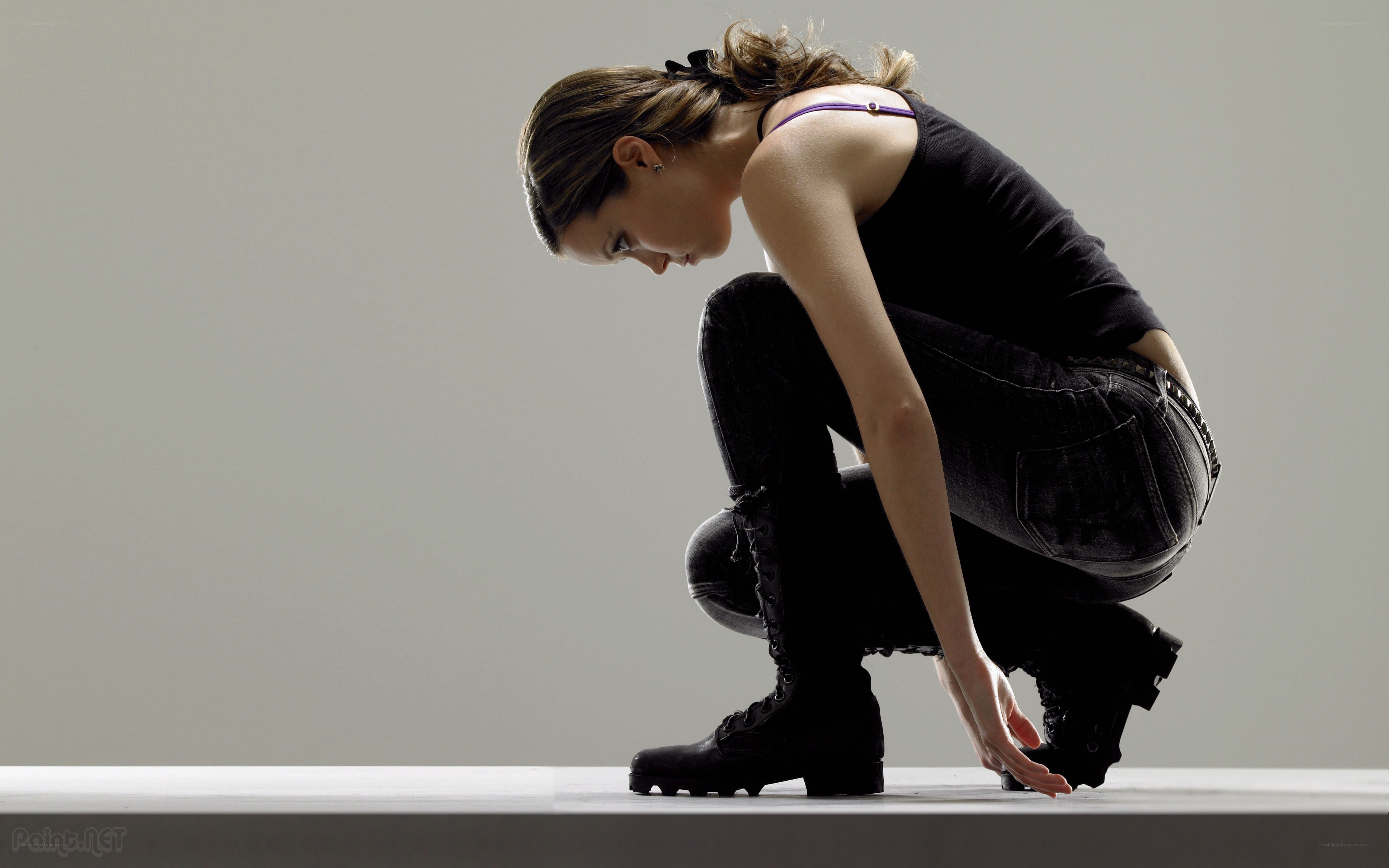 woman crouching on platform