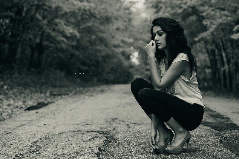 woman crouching on road