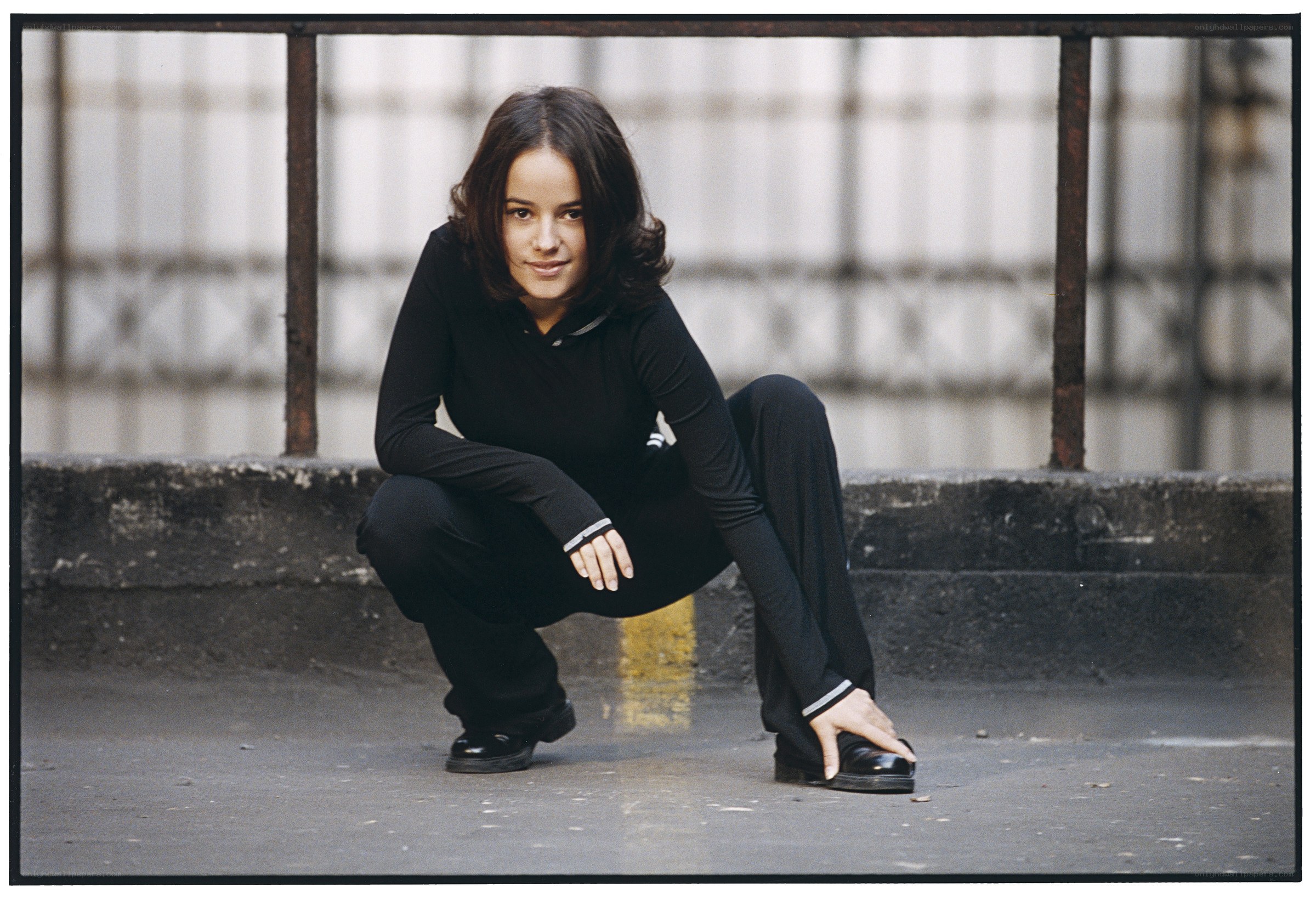 woman crouching on street