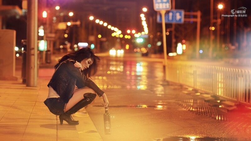 woman crouching on wet street