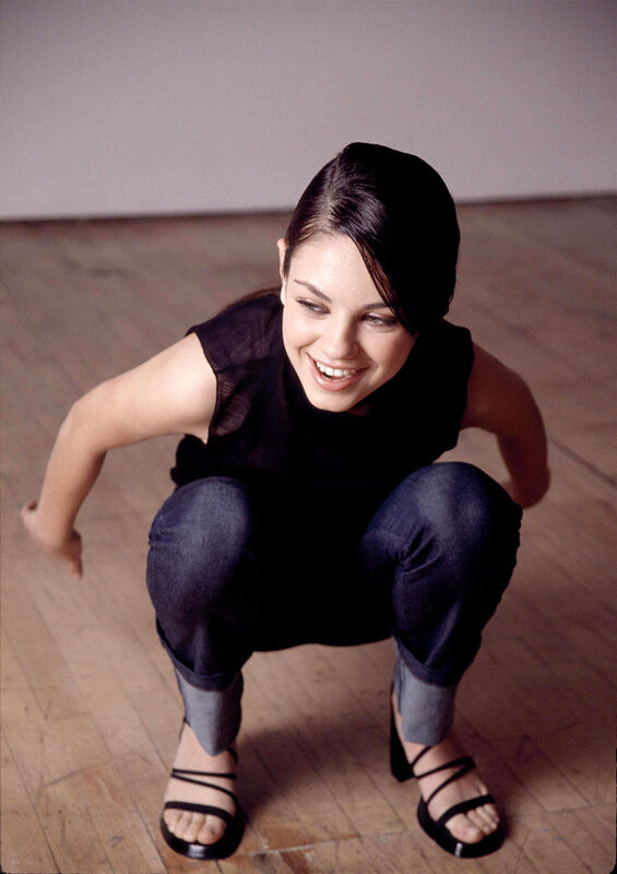 woman crouching on wooden floor