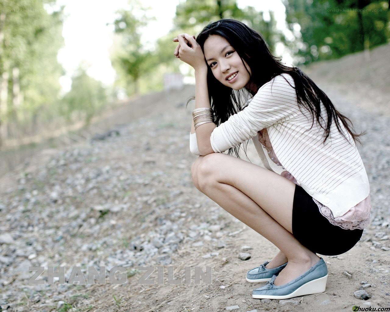 woman crouching outdoors
