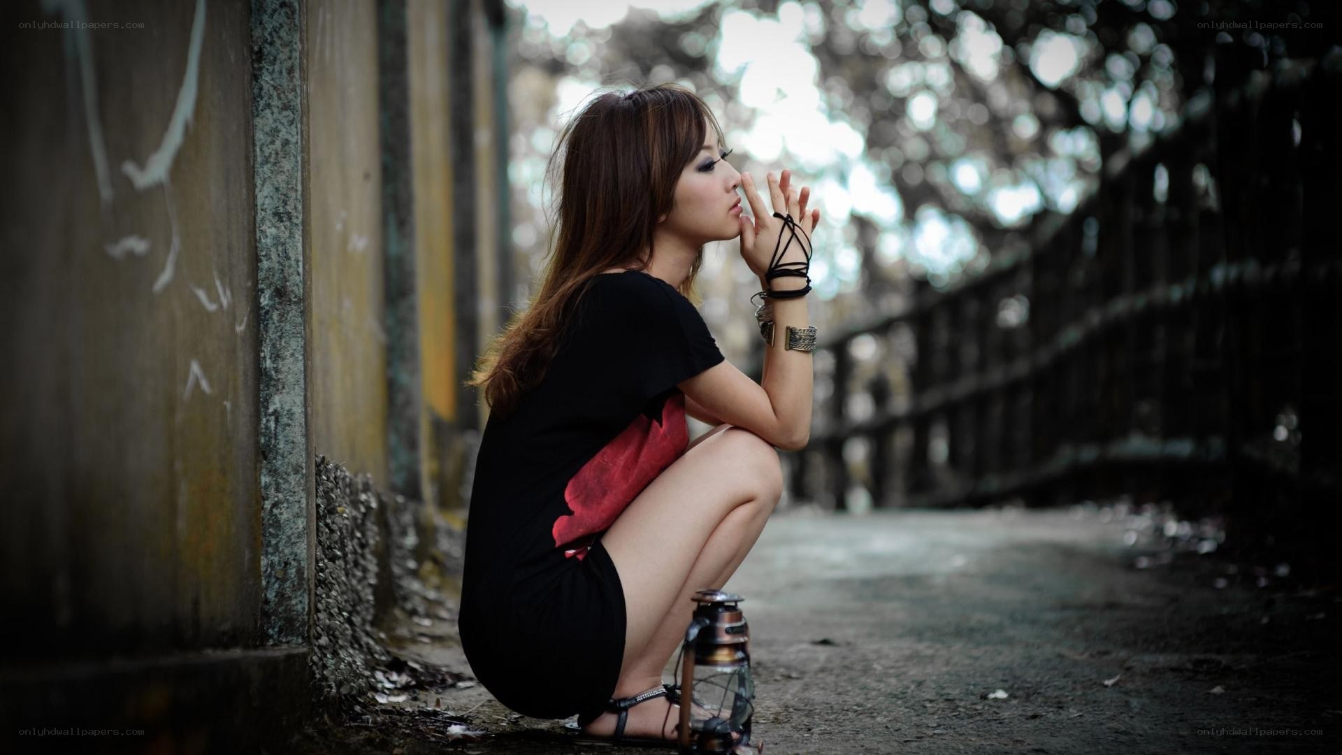 Woman crouching with lantern