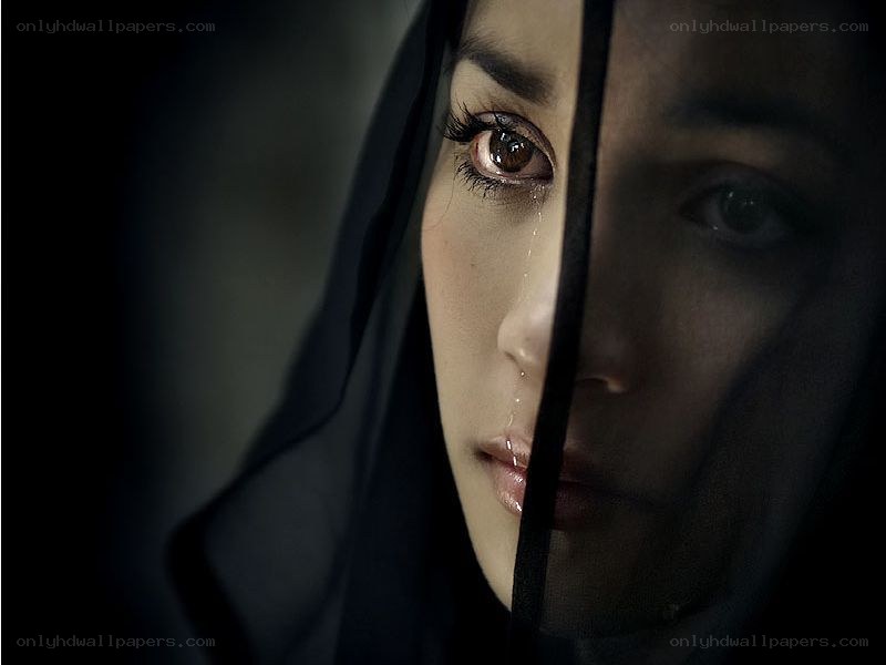 woman crying behind veil