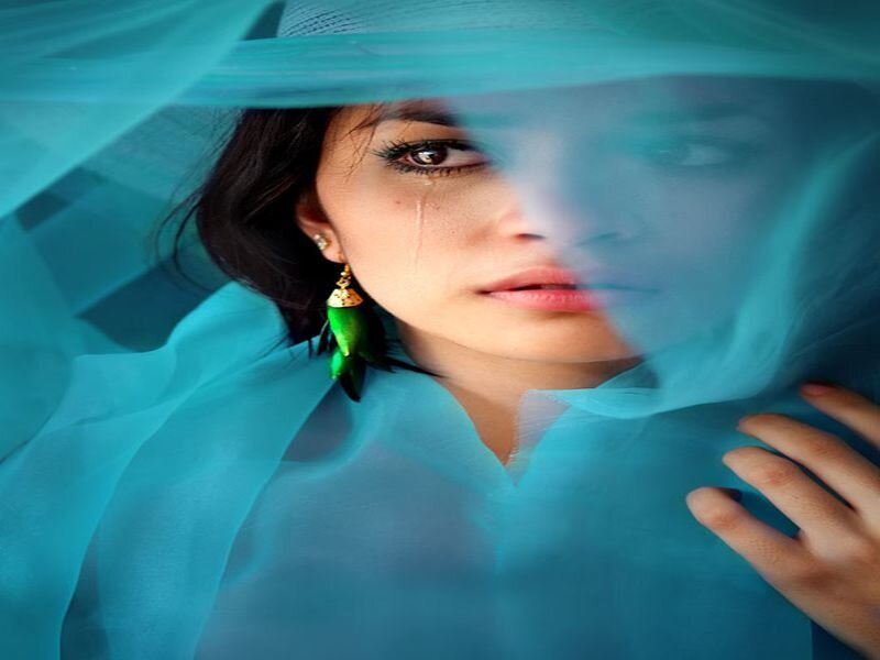 woman crying behind veil