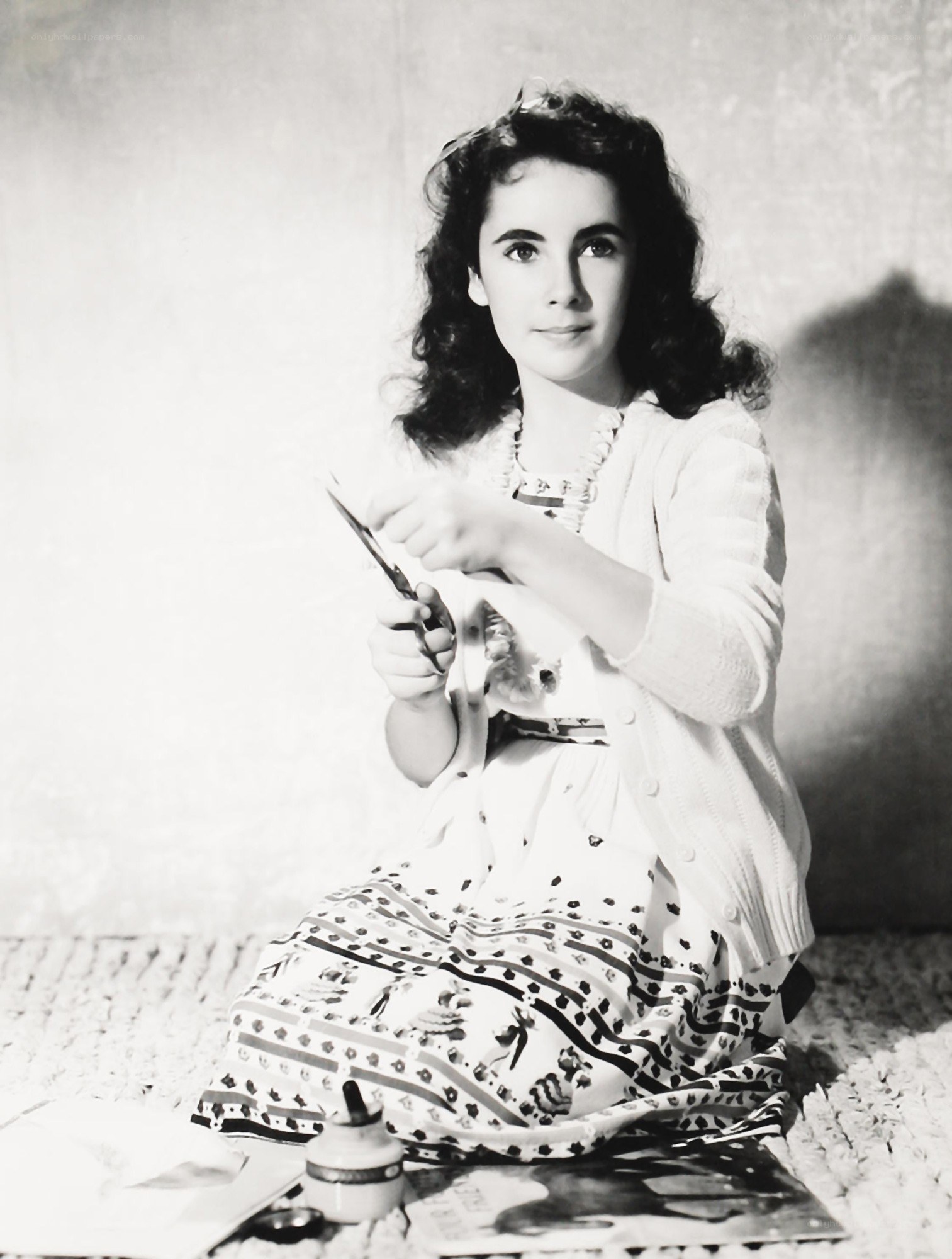 woman cutting paper with scissors
