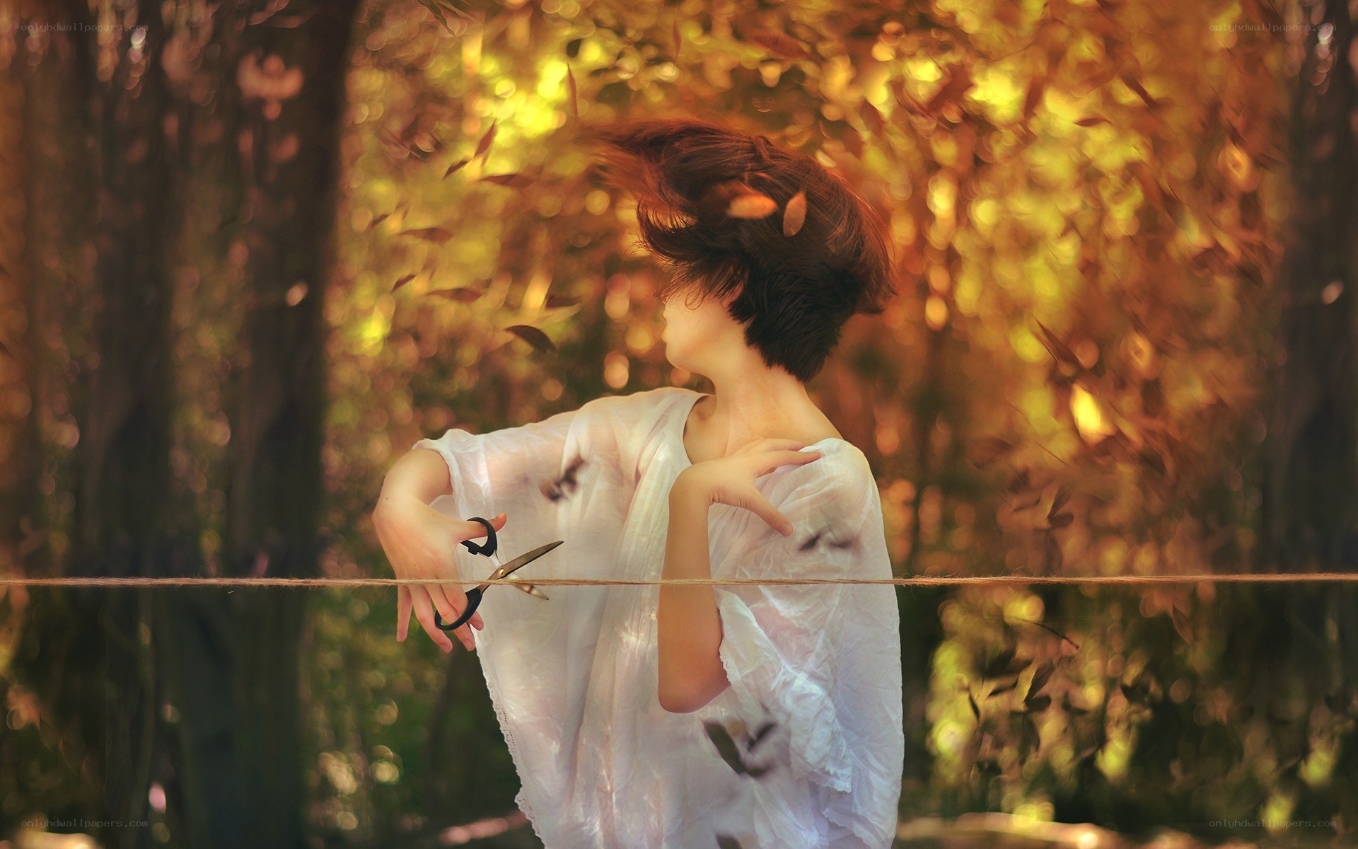 woman cutting string in autumn forest