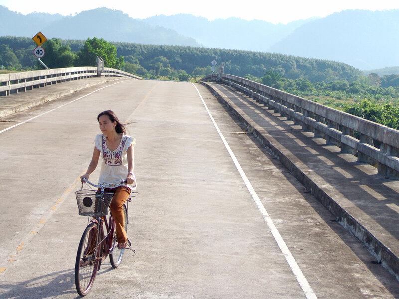 Woman cycling on a bridge