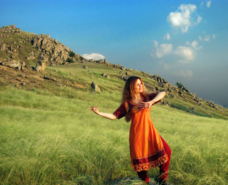 Woman dancing in a grassy field