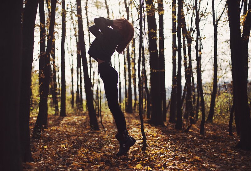 Woman dancing in autumn forest