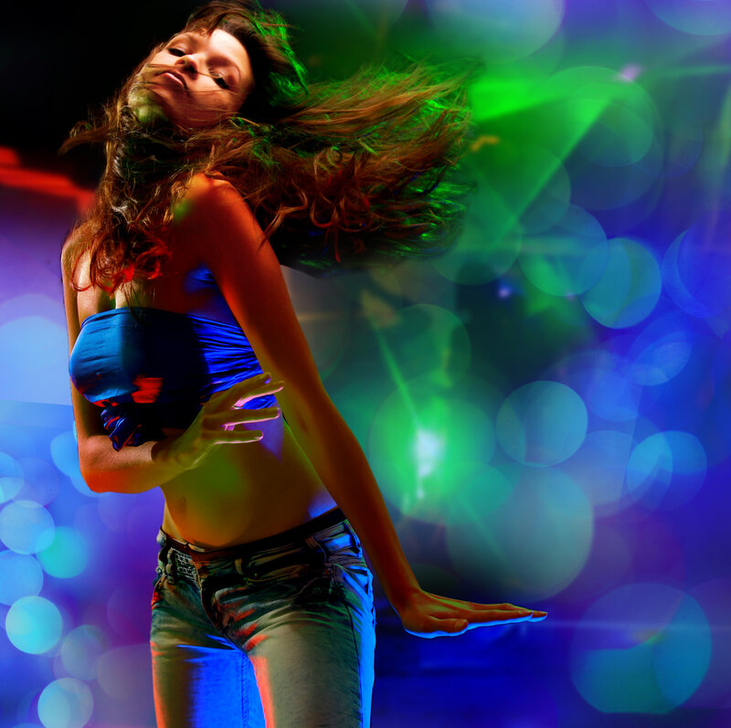 woman dancing in colorful lights