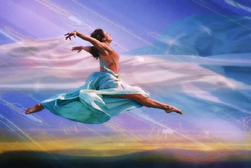 woman dancing in colorful sky