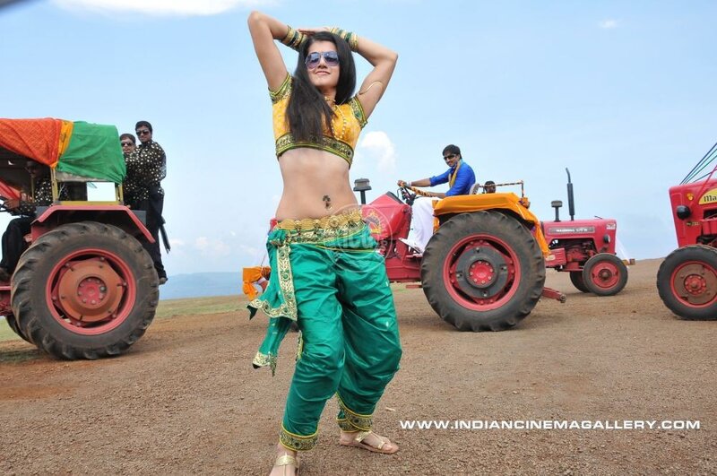 Woman dancing in field with tractors