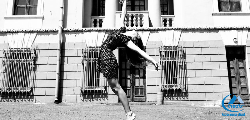 Woman Dancing in Front of Building