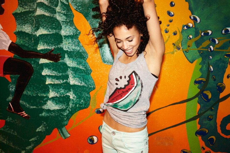 woman dancing in front of mural
