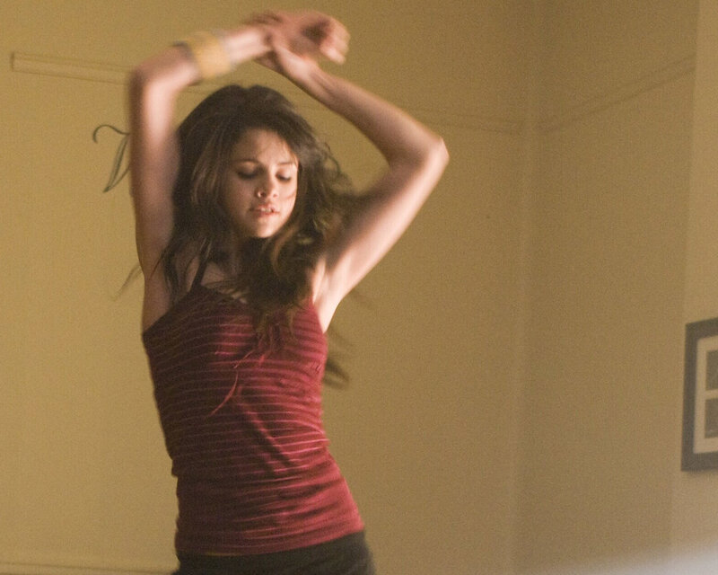 woman dancing in red top