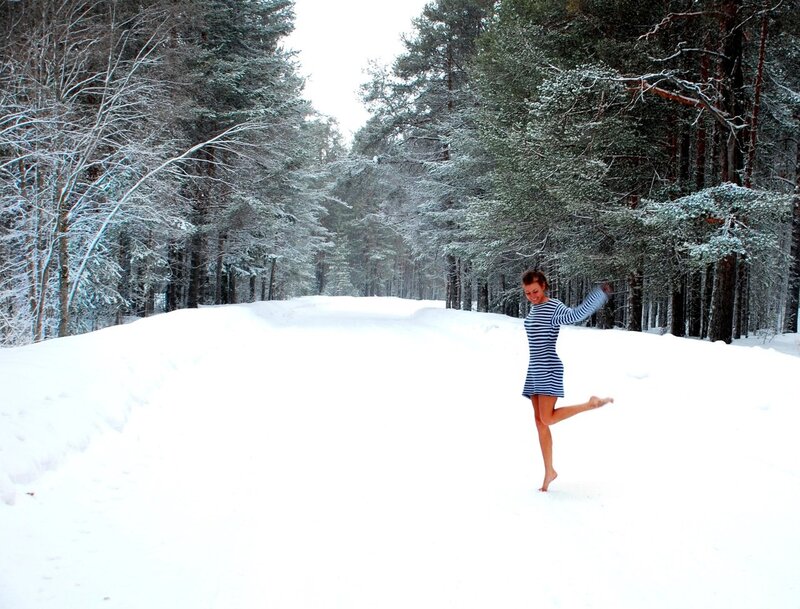 Woman dancing in snowy forest