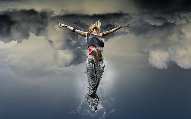 woman dancing in stormy sky