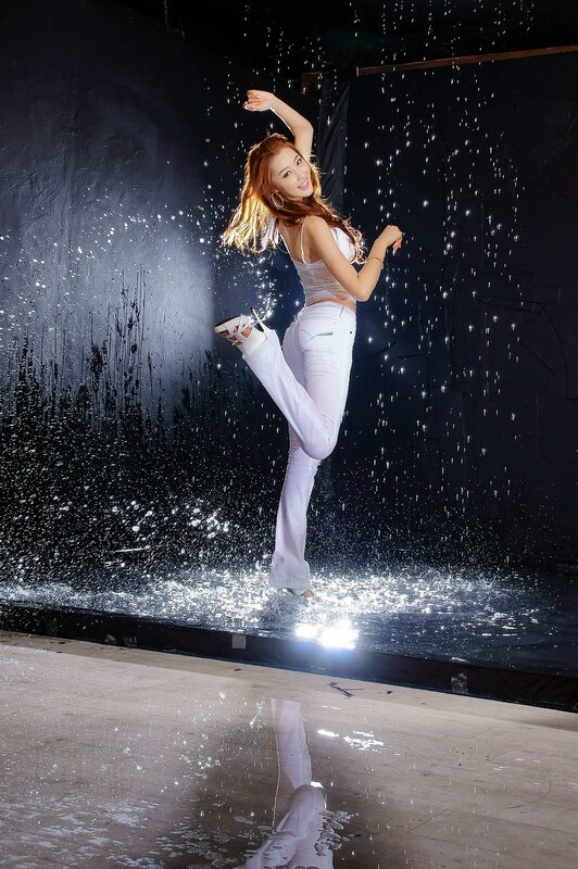 woman dancing in water spray