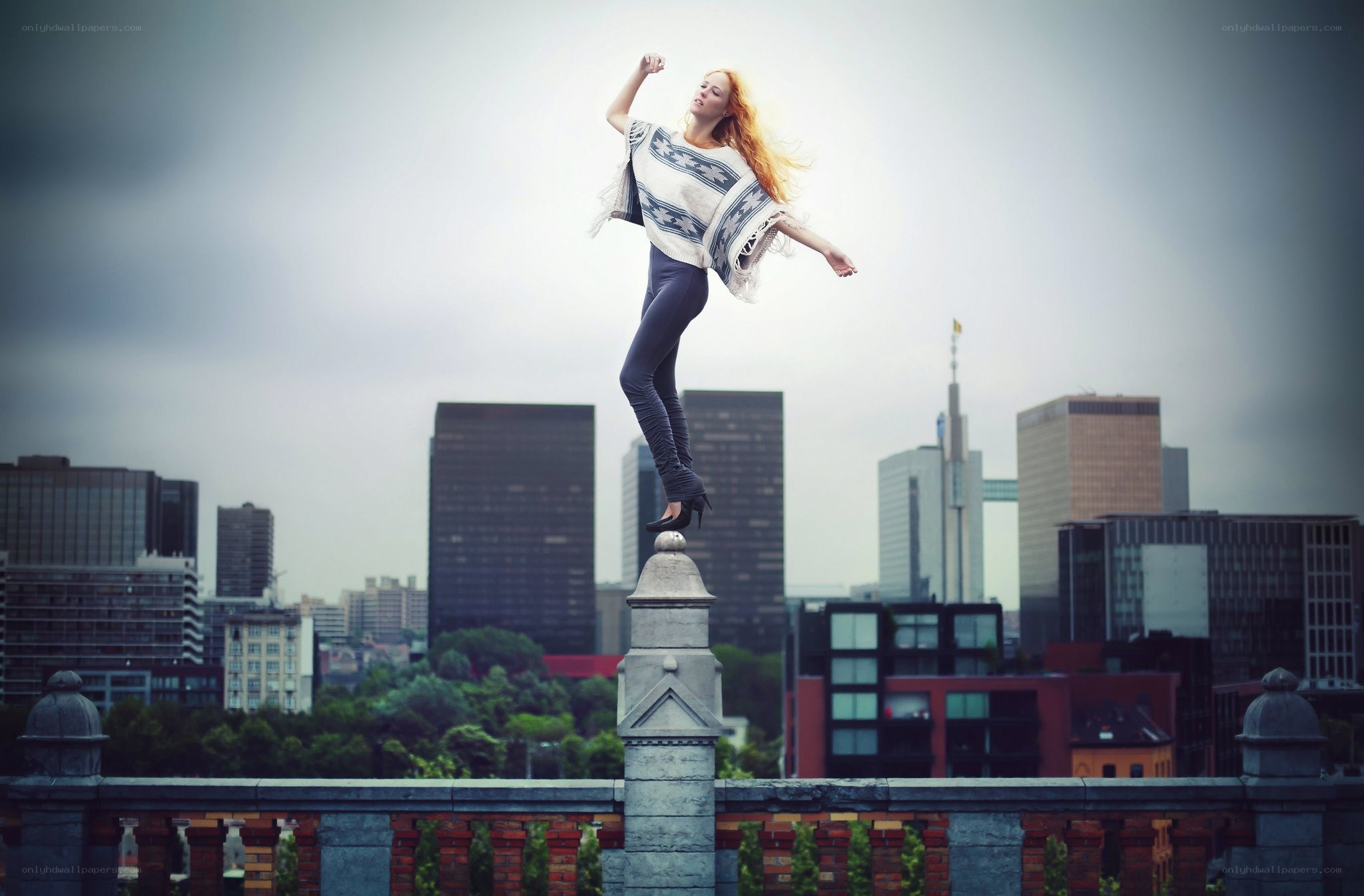 Woman dancing on a city rooftop