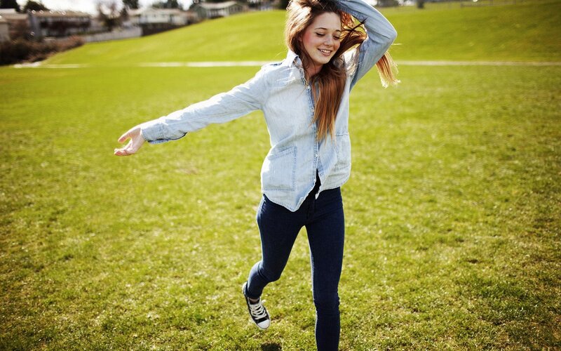 woman dancing on a grassy field