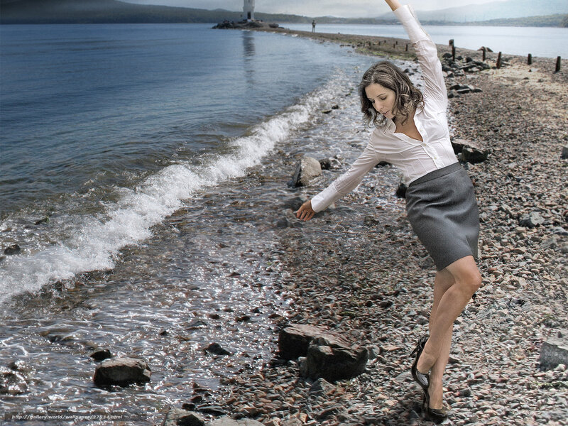 Woman dancing on a pebble beach