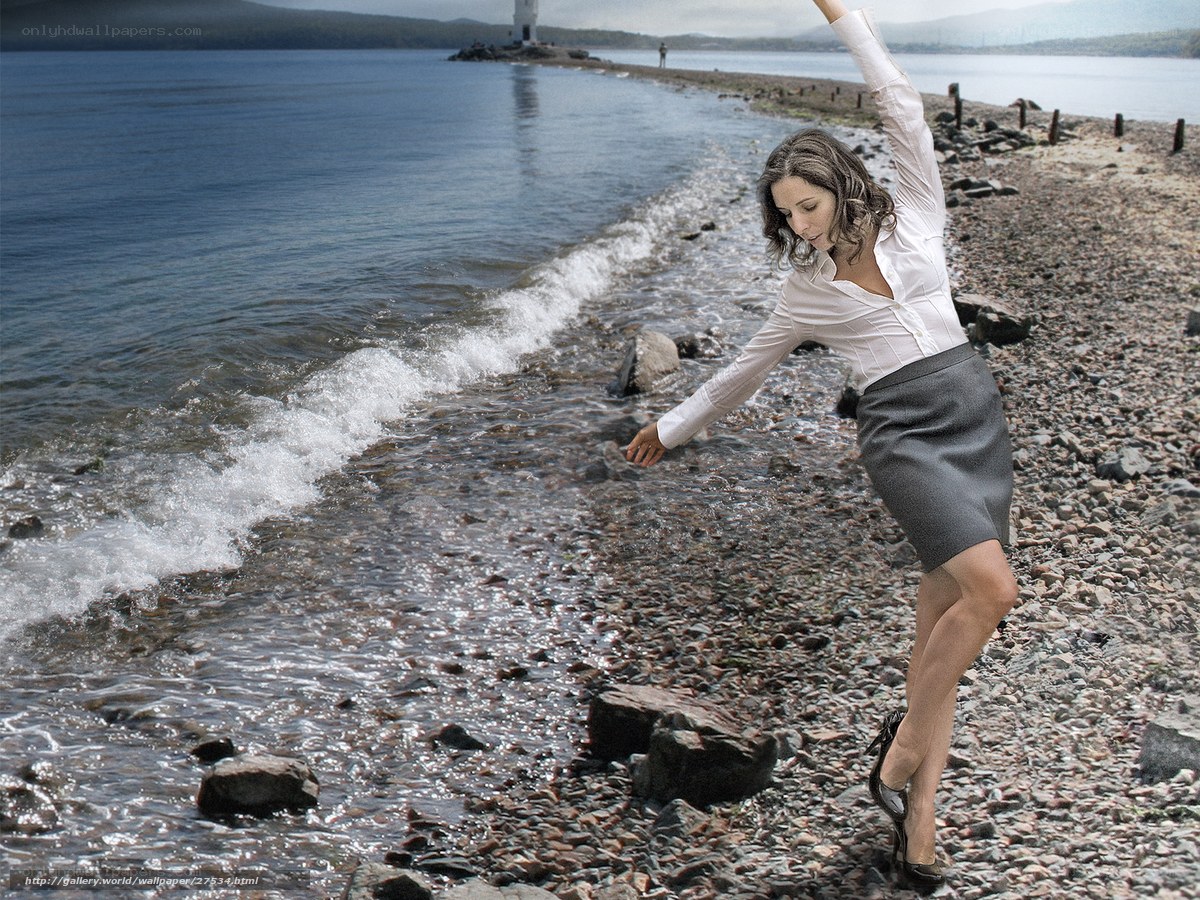 Woman dancing on a pebble beach