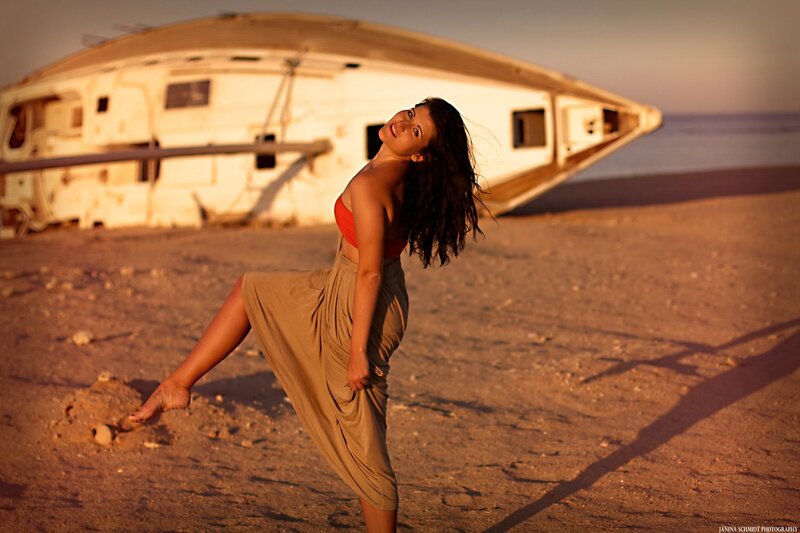 woman dancing on beach at sunset