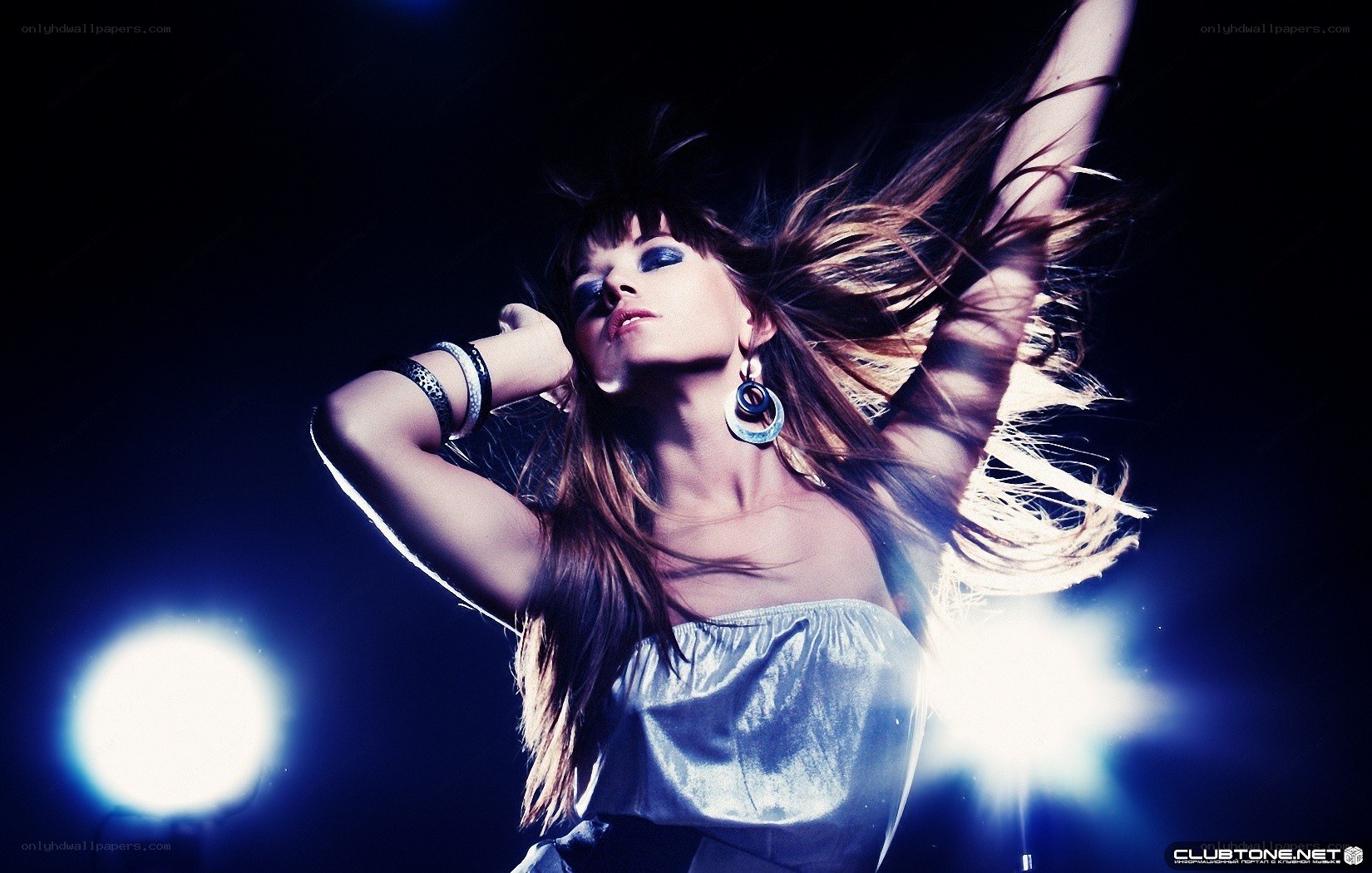 woman dancing under blue lights