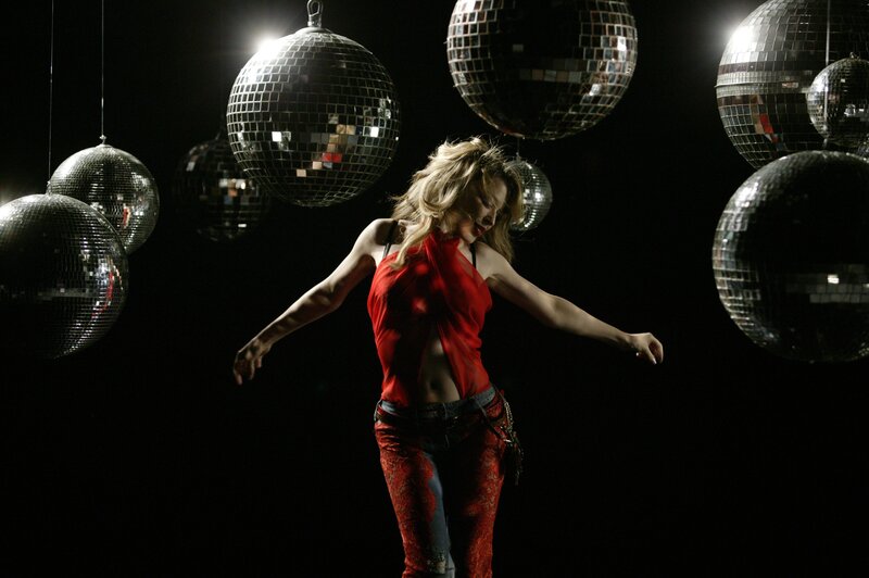 woman dancing with disco balls