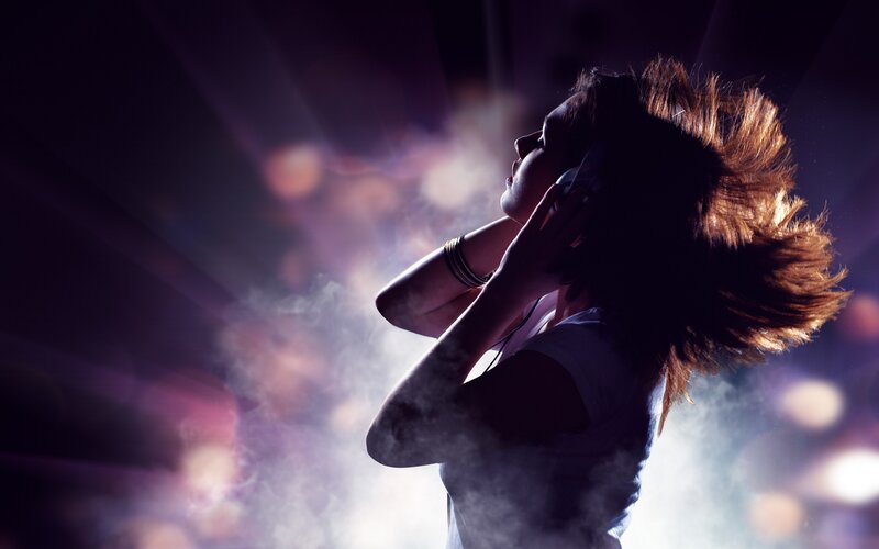 woman dancing with headphones