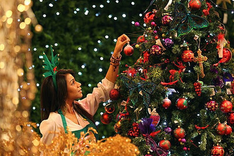 Woman Decorating Christmas Tree — Green, Festive