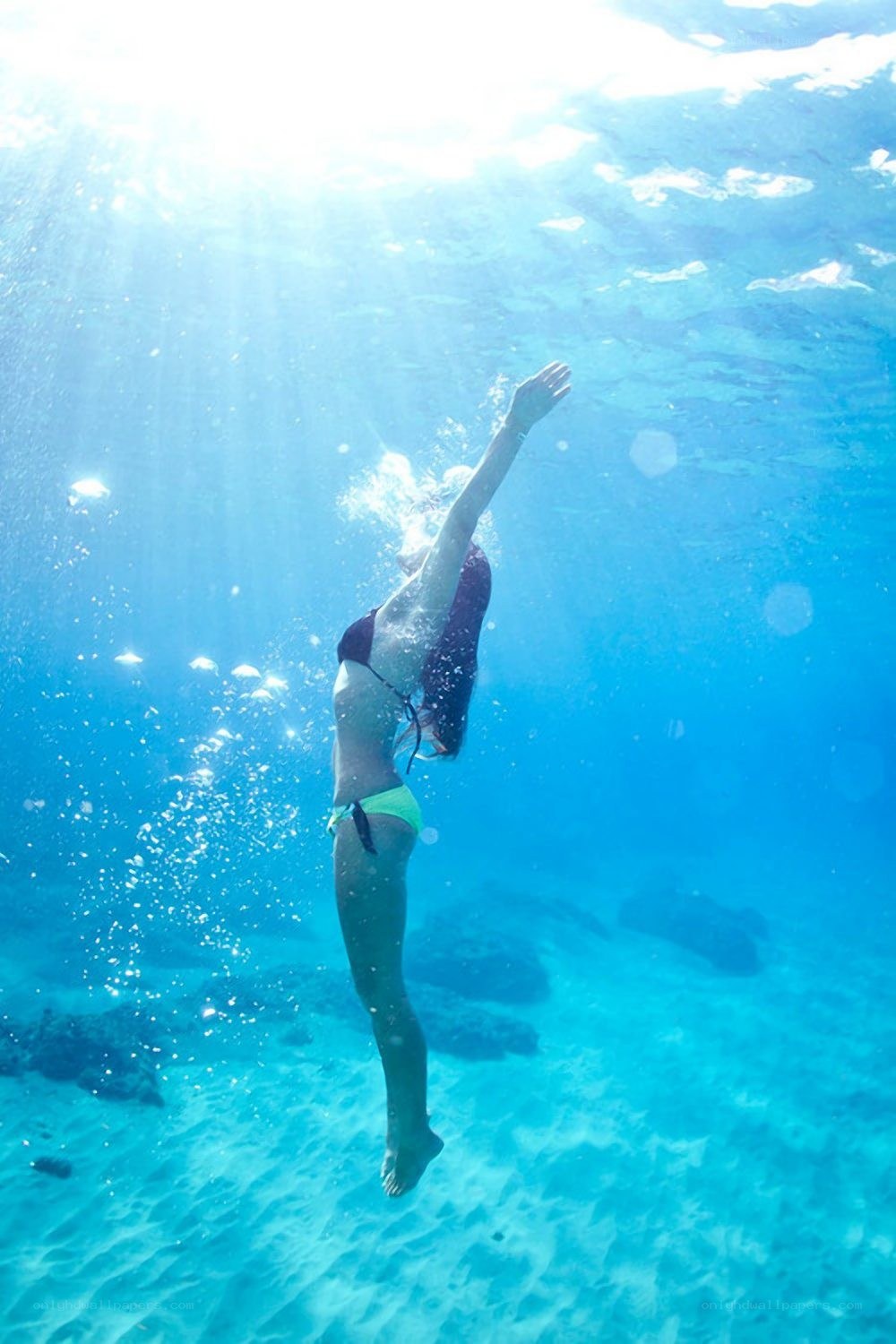 woman diving underwater