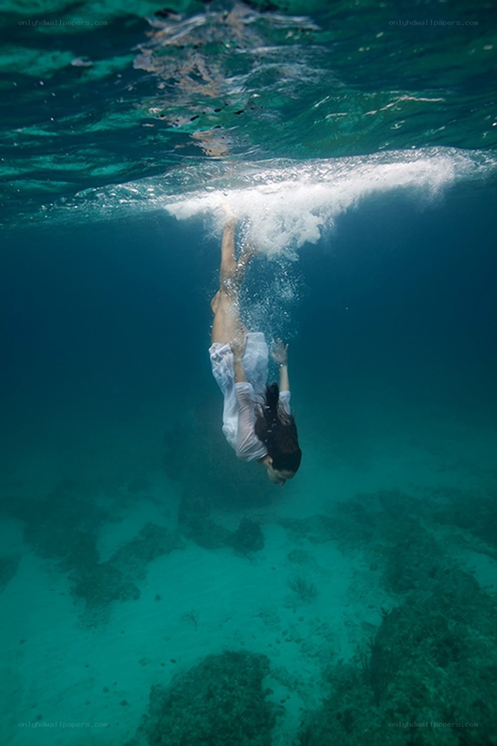 woman diving underwater
